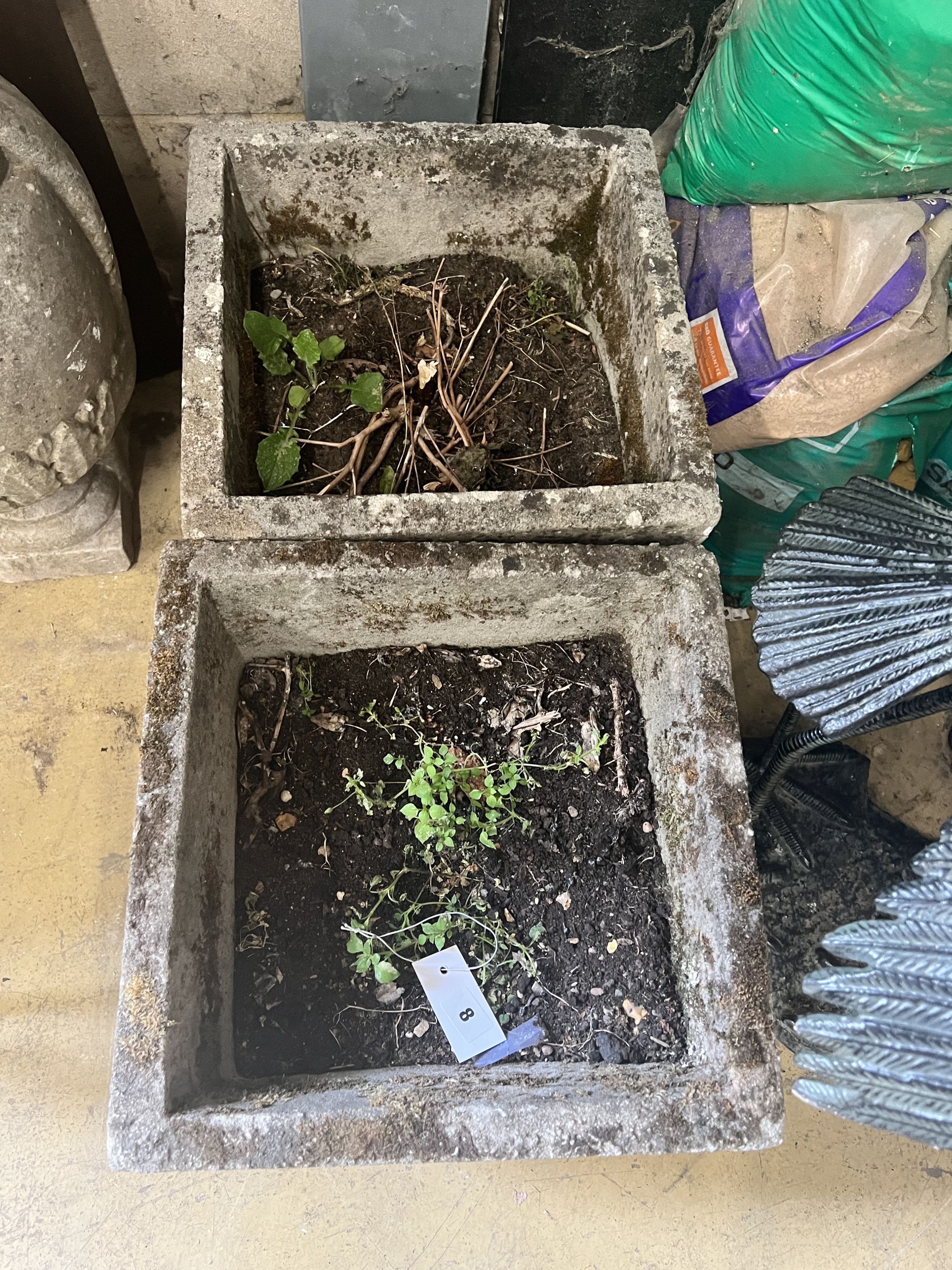 A pair of reconstituted stone square planters with rose motif, width 37cm height 36cm